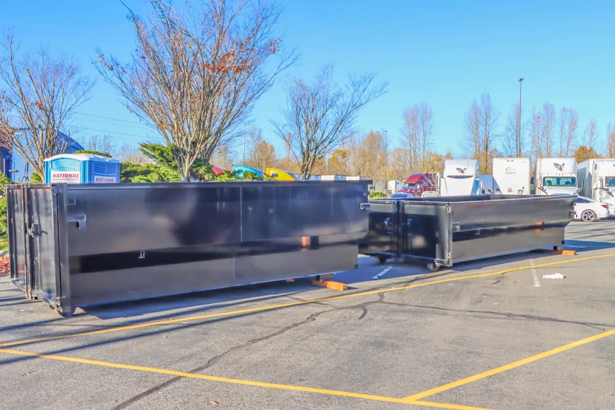 Professional dumpster rental service with roll-off container on residential driveway in South Lakes